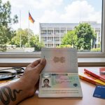 Indian nurse holding a German work visa approval document at the German Embassy in New Delhi