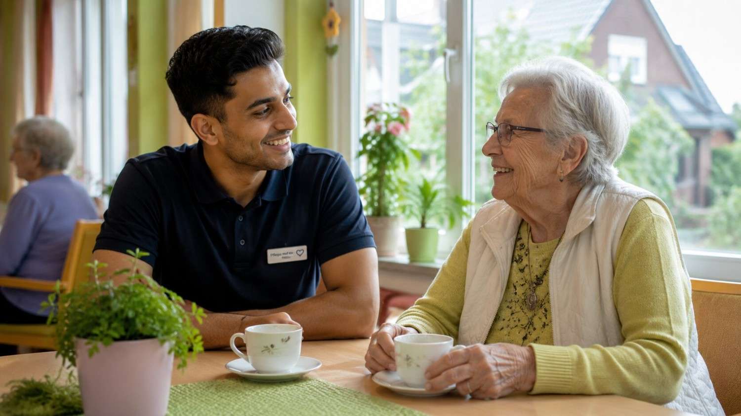 Indian healthcare trainee supporting an elderly resident in a German care home during a caregiving Ausbildung